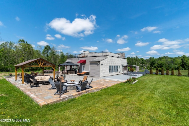 rear view of property featuring a gazebo, a yard, a patio, and an outdoor living space with a fire pit