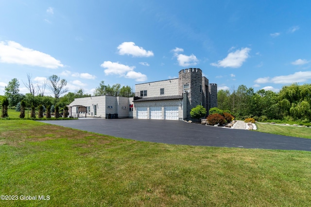 view of front of property featuring a garage and a front lawn