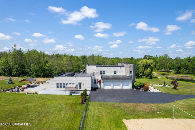 exterior space featuring a garage and a yard