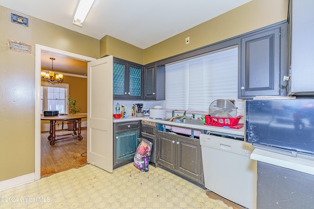 kitchen with sink, dishwasher, hanging light fixtures, and an inviting chandelier