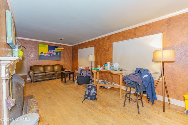 living room with crown molding and light hardwood / wood-style flooring