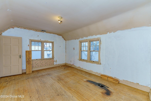 interior space with hardwood / wood-style floors and lofted ceiling