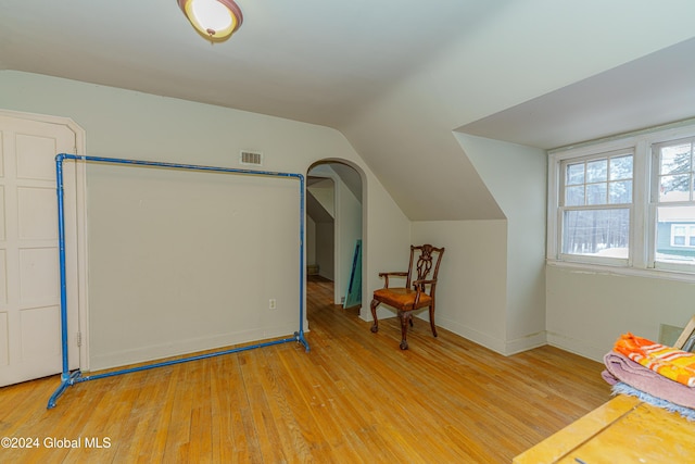 bonus room with light hardwood / wood-style floors and vaulted ceiling