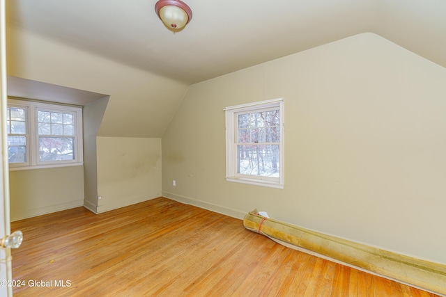 bonus room featuring hardwood / wood-style flooring and vaulted ceiling