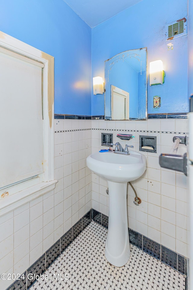 bathroom with tile patterned flooring and tile walls