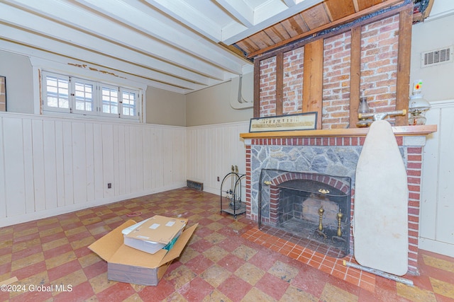 living room with wooden walls and a fireplace