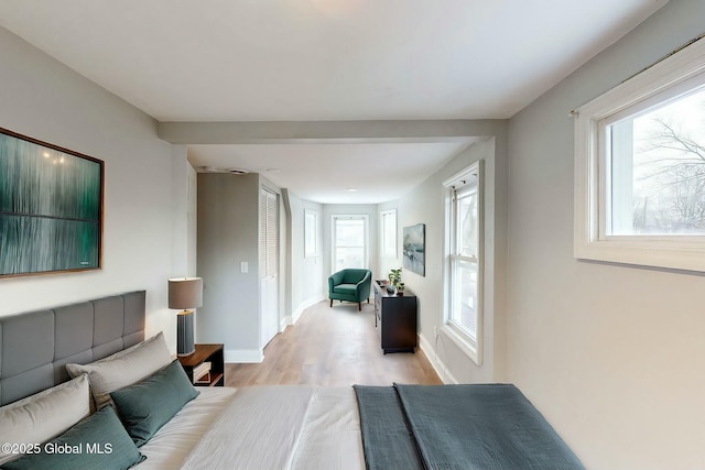 living area with baseboards and light wood-type flooring