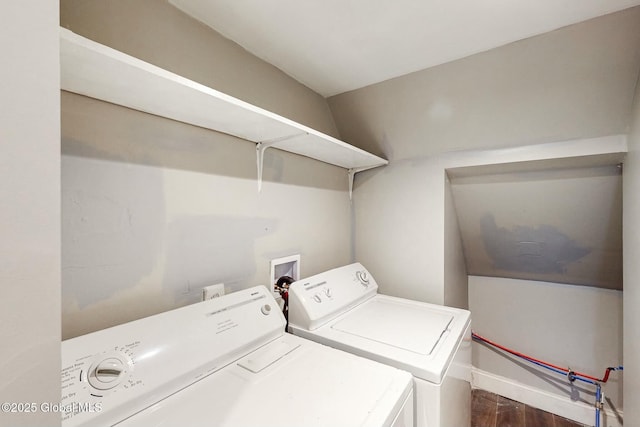 washroom with dark wood-type flooring, laundry area, washing machine and clothes dryer, and baseboards