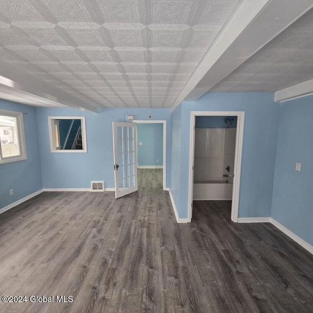 empty room with french doors and dark hardwood / wood-style flooring