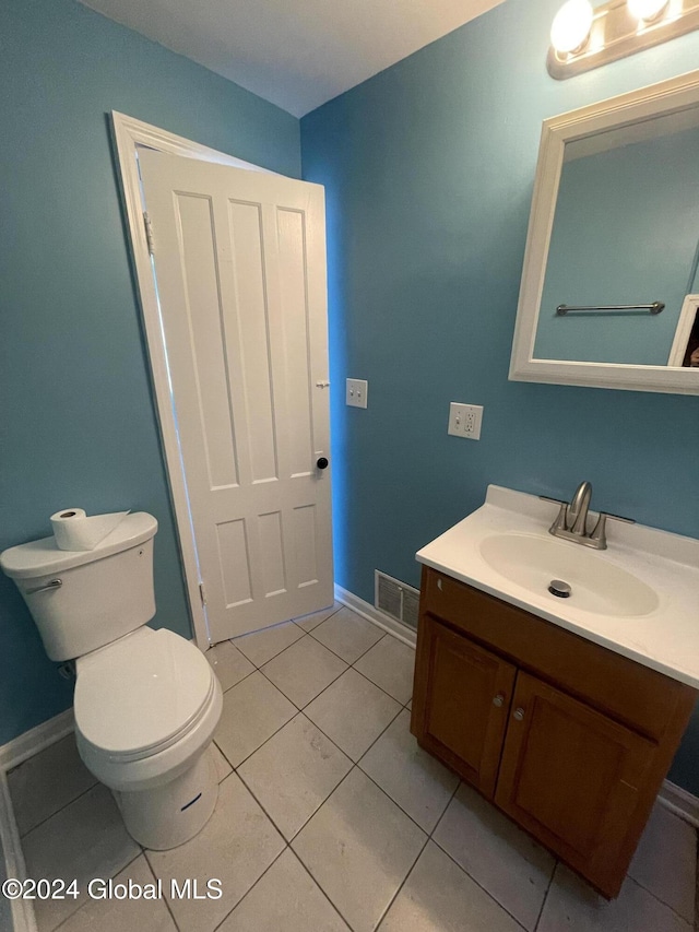 bathroom featuring tile patterned floors, vanity, and toilet