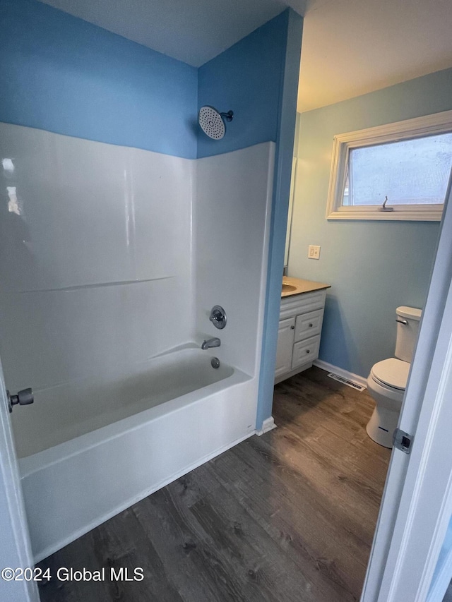 full bathroom featuring toilet, vanity, shower / bath combination, and hardwood / wood-style flooring