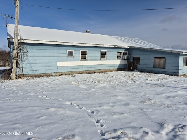 snow covered property featuring cooling unit