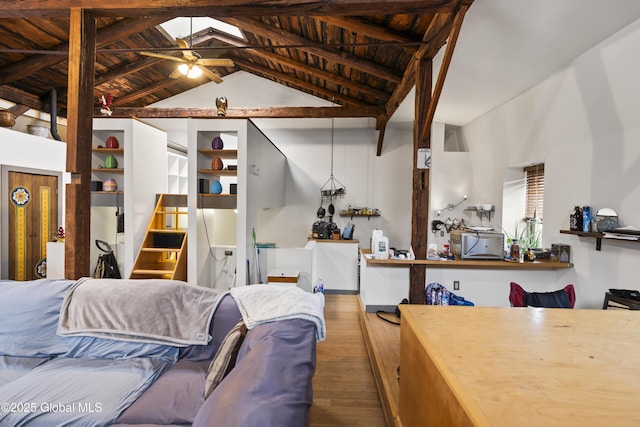 living room featuring ceiling fan, wooden ceiling, hardwood / wood-style flooring, and lofted ceiling with beams