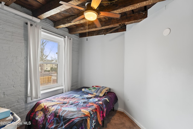 bedroom with ceiling fan, carpet flooring, wood ceiling, and beamed ceiling