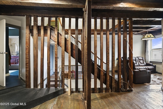 miscellaneous room with hardwood / wood-style flooring and beam ceiling