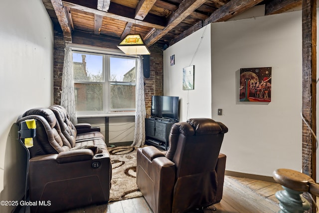 living room featuring beam ceiling, light hardwood / wood-style flooring, and wooden ceiling