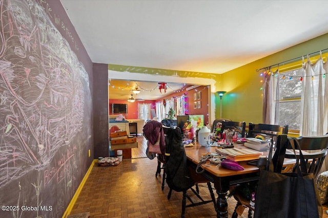 dining space featuring parquet floors