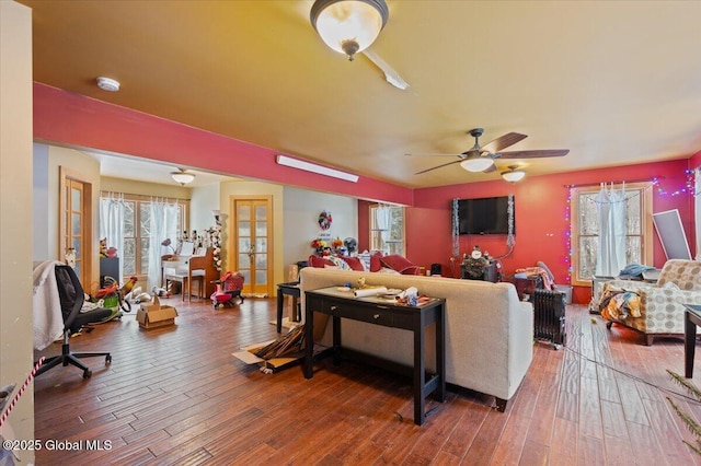 living room with french doors, ceiling fan, and hardwood / wood-style floors