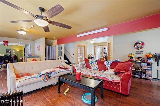 living room with ceiling fan and dark hardwood / wood-style floors