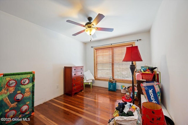 game room featuring dark hardwood / wood-style flooring and ceiling fan