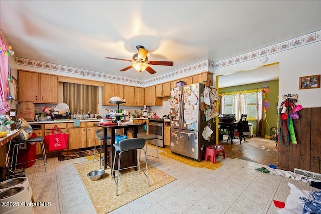 kitchen featuring ceiling fan and stainless steel appliances