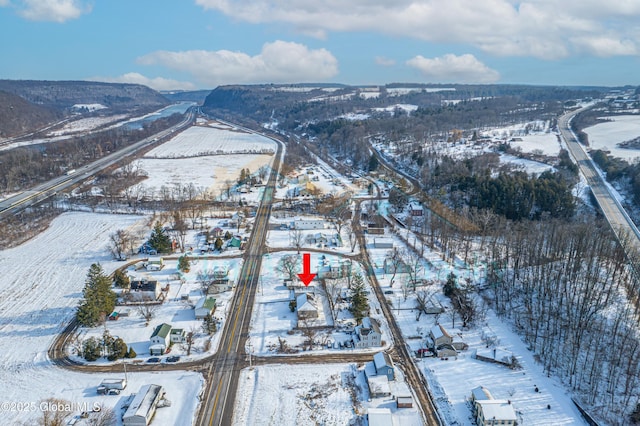 snowy aerial view with a mountain view