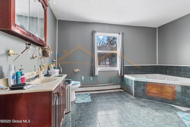 bathroom featuring vanity, tile patterned floors, toilet, tiled tub, and a baseboard radiator