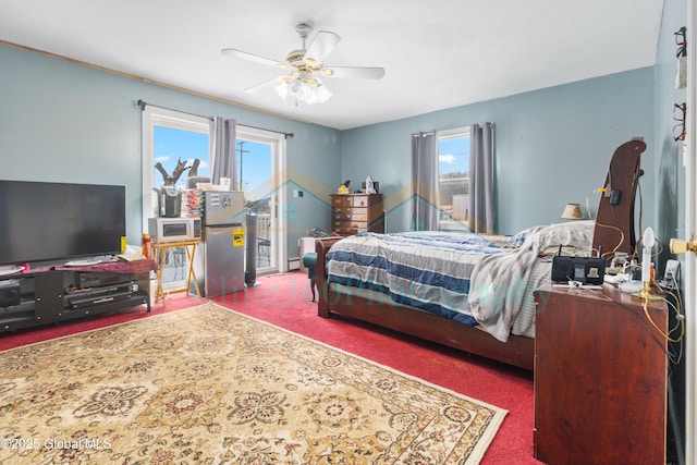 bedroom featuring carpet, ceiling fan, and multiple windows