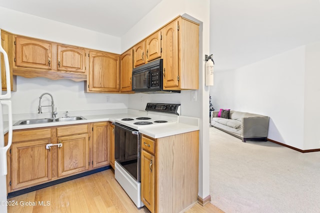 kitchen with white range with electric stovetop, light wood-type flooring, and sink