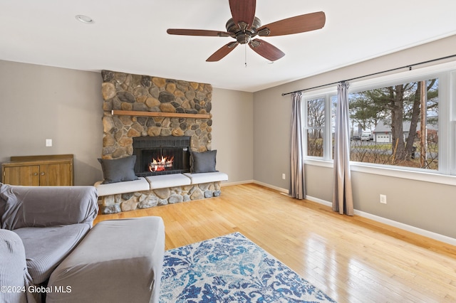 living room with a fireplace, hardwood / wood-style flooring, and ceiling fan