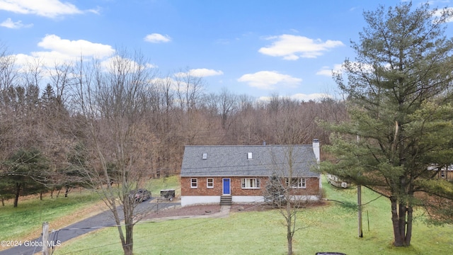 view of front facade featuring a front yard and a patio area