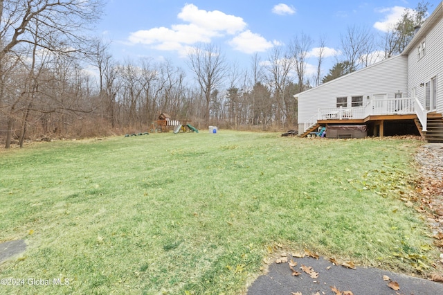 view of yard with a deck and a playground