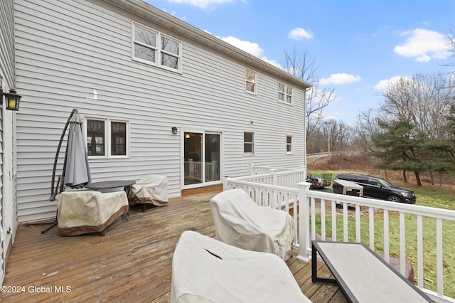 wooden terrace with a yard