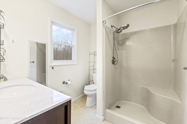 bathroom with walk in shower, tile patterned floors, vanity, and toilet