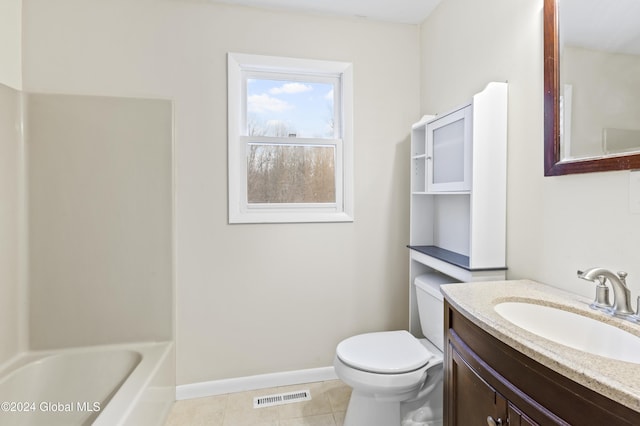 bathroom with tile patterned floors, vanity, and toilet