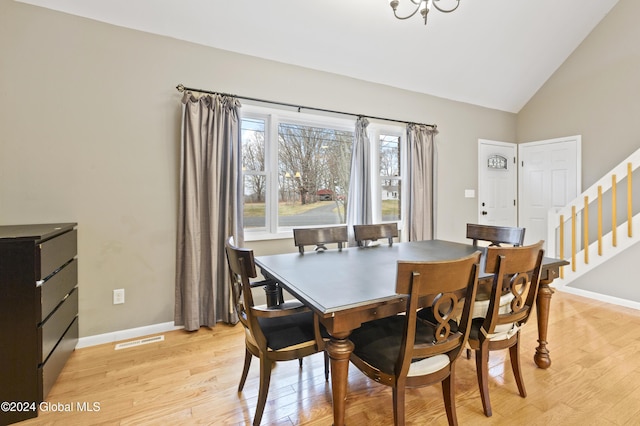 dining room featuring light hardwood / wood-style flooring and vaulted ceiling