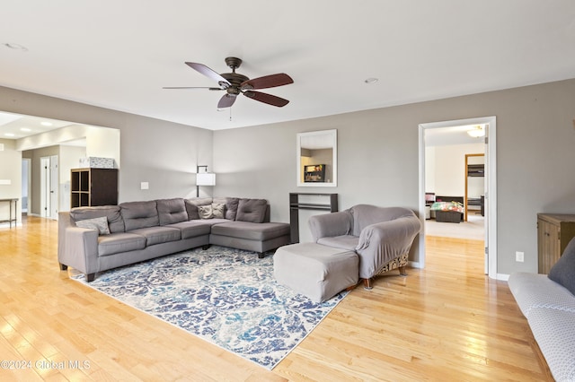 living room with ceiling fan and hardwood / wood-style flooring