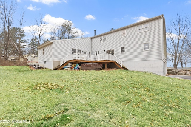 back of house featuring a wooden deck and a lawn