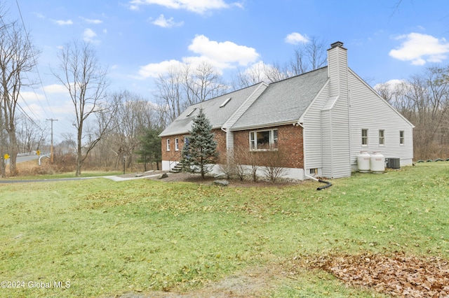 view of home's exterior featuring a lawn and cooling unit