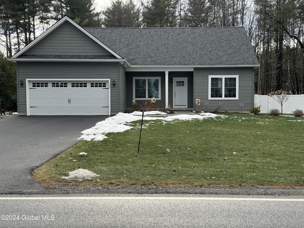 view of front of house featuring a garage and a front yard