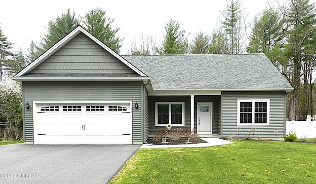 ranch-style house with a front lawn, driveway, a garage, and a shingled roof