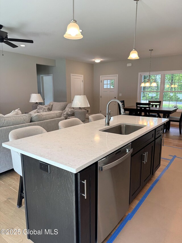 176 Butler Rd, Moreau, NY 12828 - kitchen featuring a sink, dishwasher, a center island with sink, open floor plan, and healthy amount of natural light