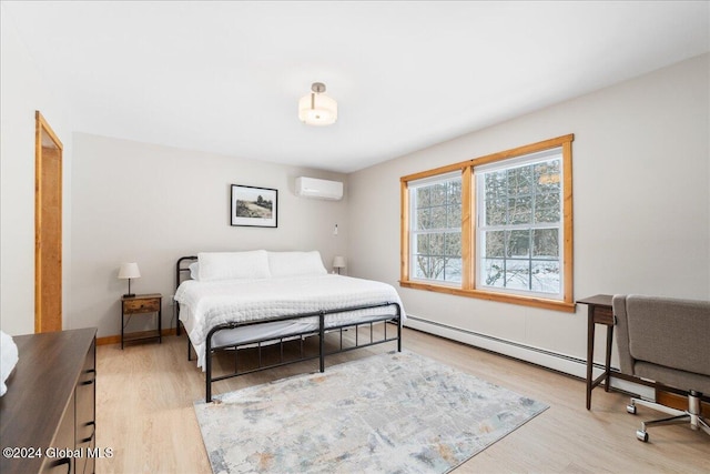 bedroom with an AC wall unit, light hardwood / wood-style floors, and a baseboard radiator