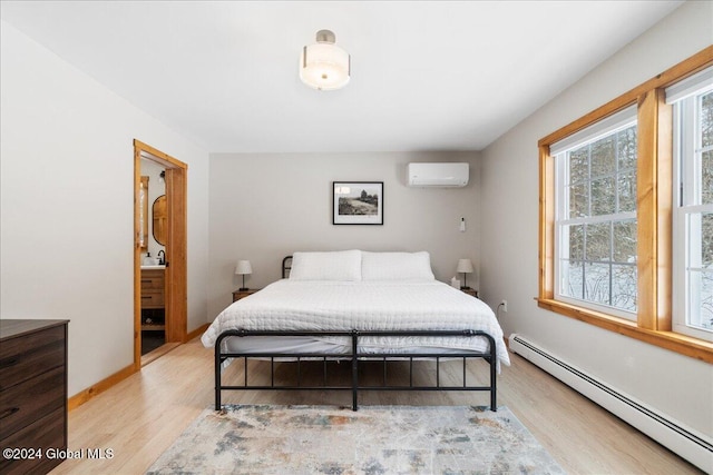 bedroom with light wood-type flooring, baseboard heating, and a wall mounted AC