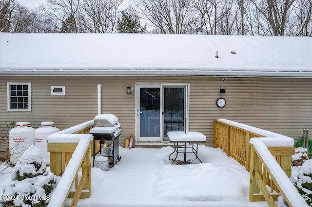 snow covered deck featuring a grill