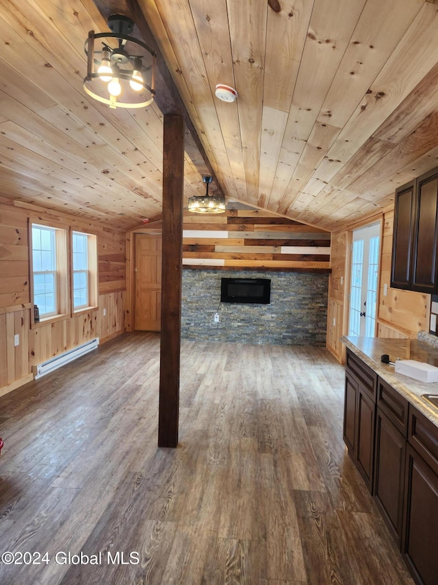 unfurnished living room with dark wood-type flooring, wooden walls, vaulted ceiling, baseboard heating, and wood ceiling