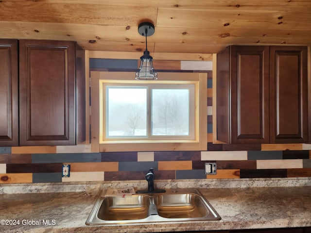 kitchen featuring dark brown cabinets, sink, wood ceiling, and decorative light fixtures