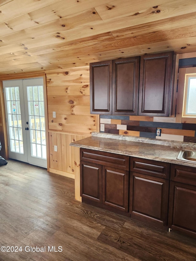 kitchen featuring wooden ceiling, french doors, wooden walls, dark hardwood / wood-style floors, and dark brown cabinetry