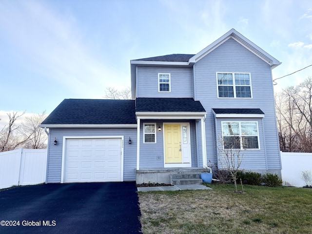 front of property with a front yard and a garage