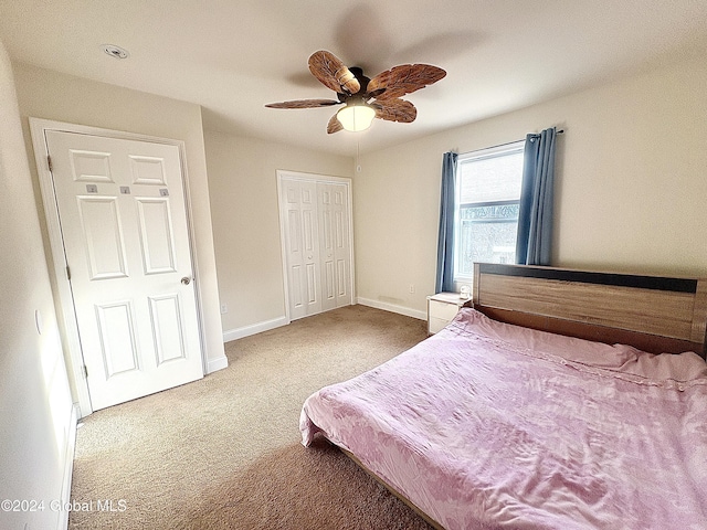 bedroom with ceiling fan, carpet floors, and a closet